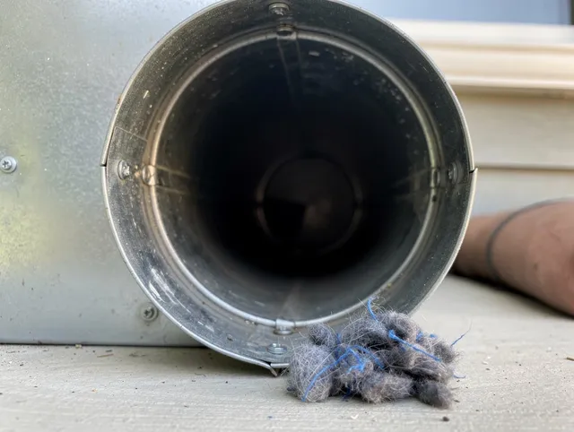 Maynard Dryer Vent Cleaning technician using specialized equipment to clear severe dryer vent blockage in Maynard